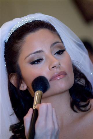 Bride getting makeup on her very pretty face!